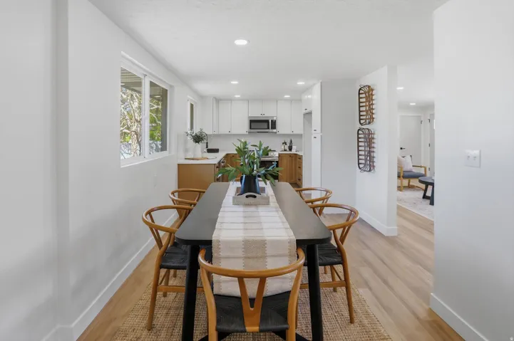 Open concept dining area with wood-finish flooring