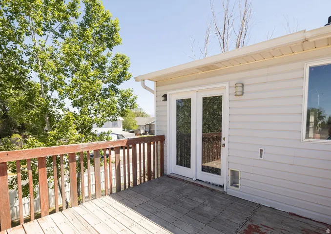 Exterior wood deck featuring a natural wood railing