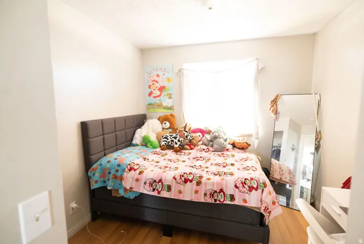 Bedroom featuring light wood-finish flooring and neutral wall tones