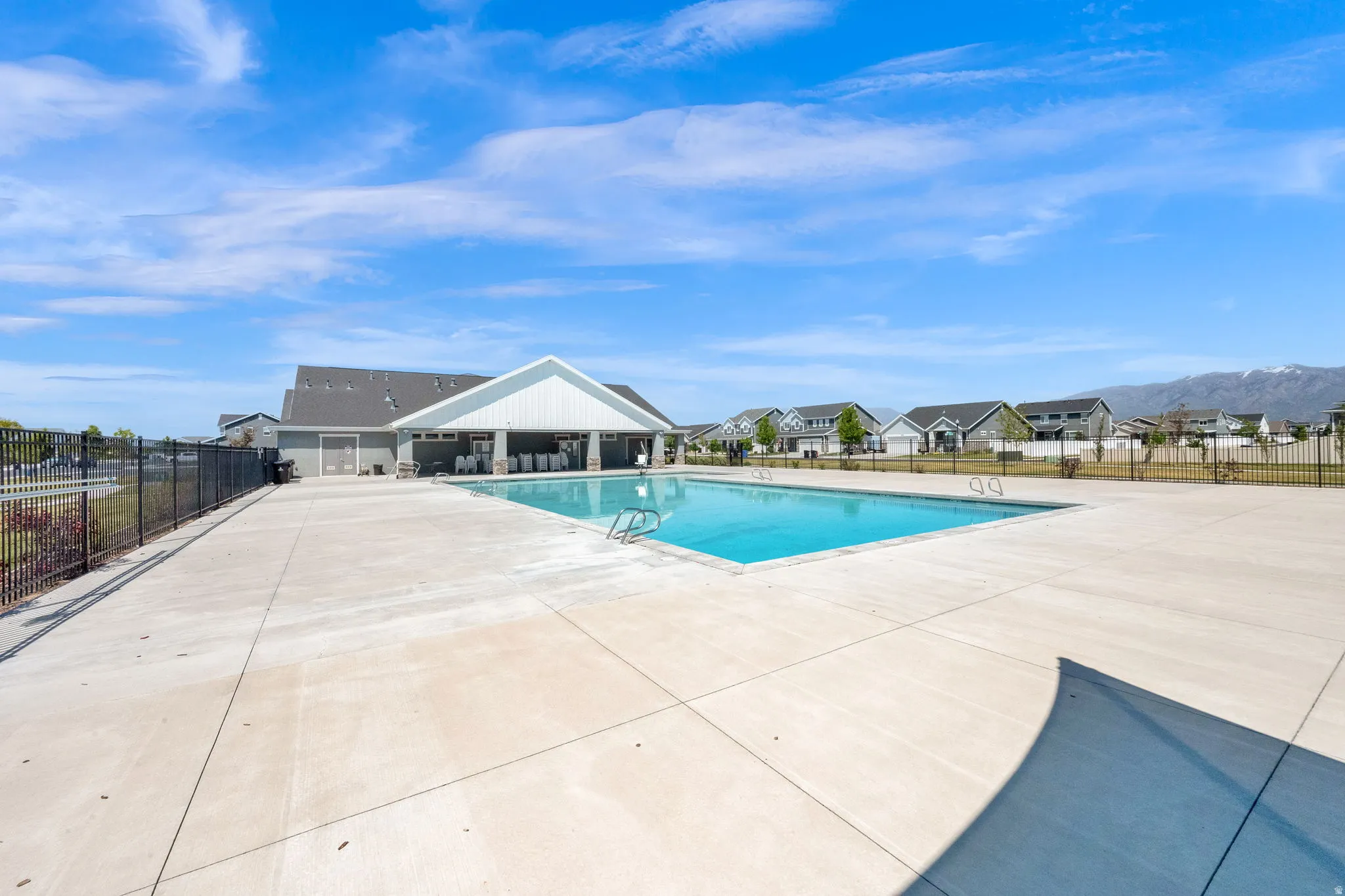 Outdoor swimming pool surrounded by a concrete deck