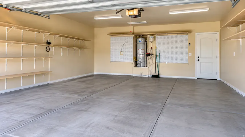 Spacious garage with light beige walls and a gray concrete floor