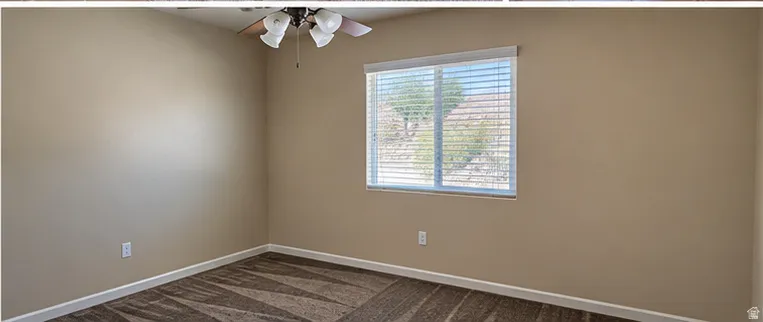 Neutral wall tones, patterned carpet, window with horizontal blinds, and a ceiling fan with integrated lighting