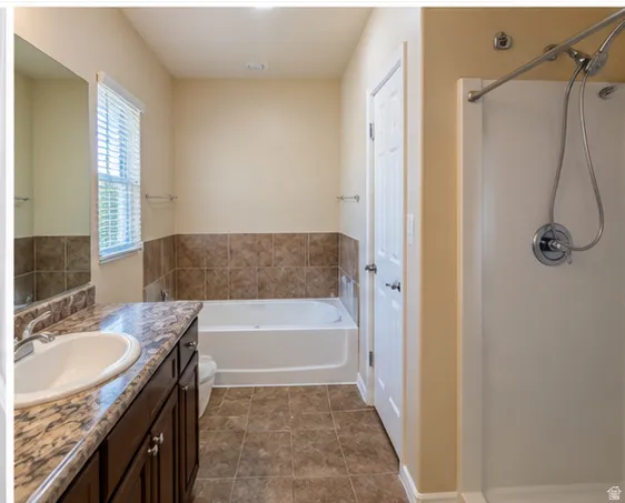 Vanity with an integrated white sink, countertop, and dark wood-finish cabinetry