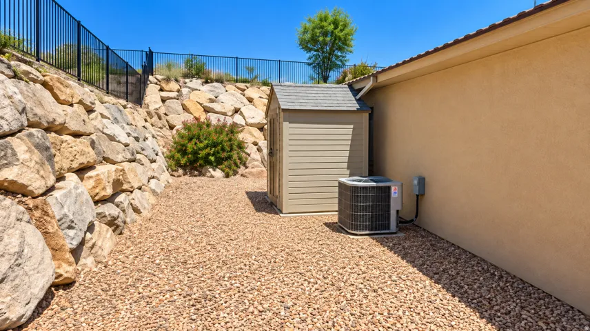 Gravel hardscaping with a storage shed and air conditioning unit