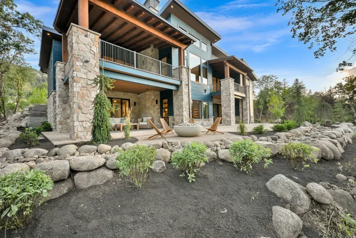 Stone and siding exterior with prominent wood beam accents