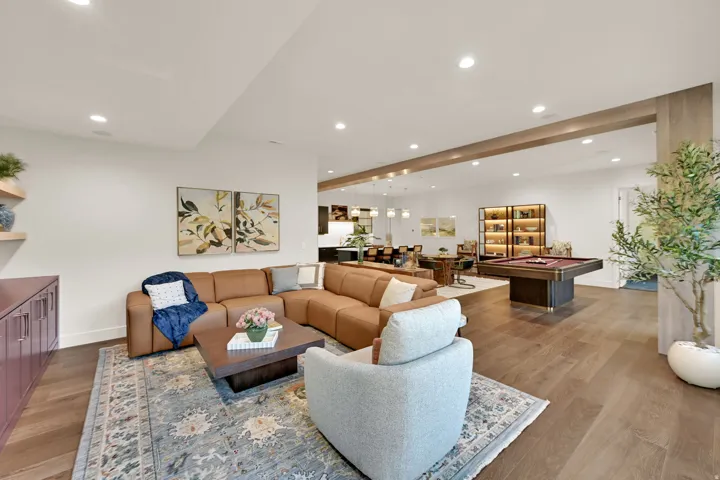 Open-concept entertaining area featuring recessed lighting, wide plank wood-finish flooring, and a dedicated billiards space