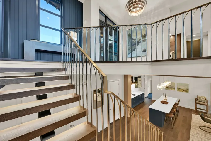 Open-riser staircase with wood-finish treads and metal railings