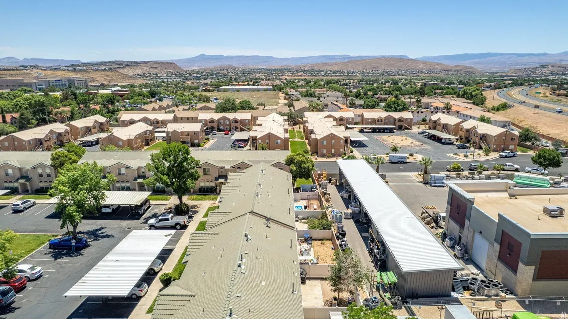 Expansive aerial perspective showcasing multiple residential buildings with tan exteriors
