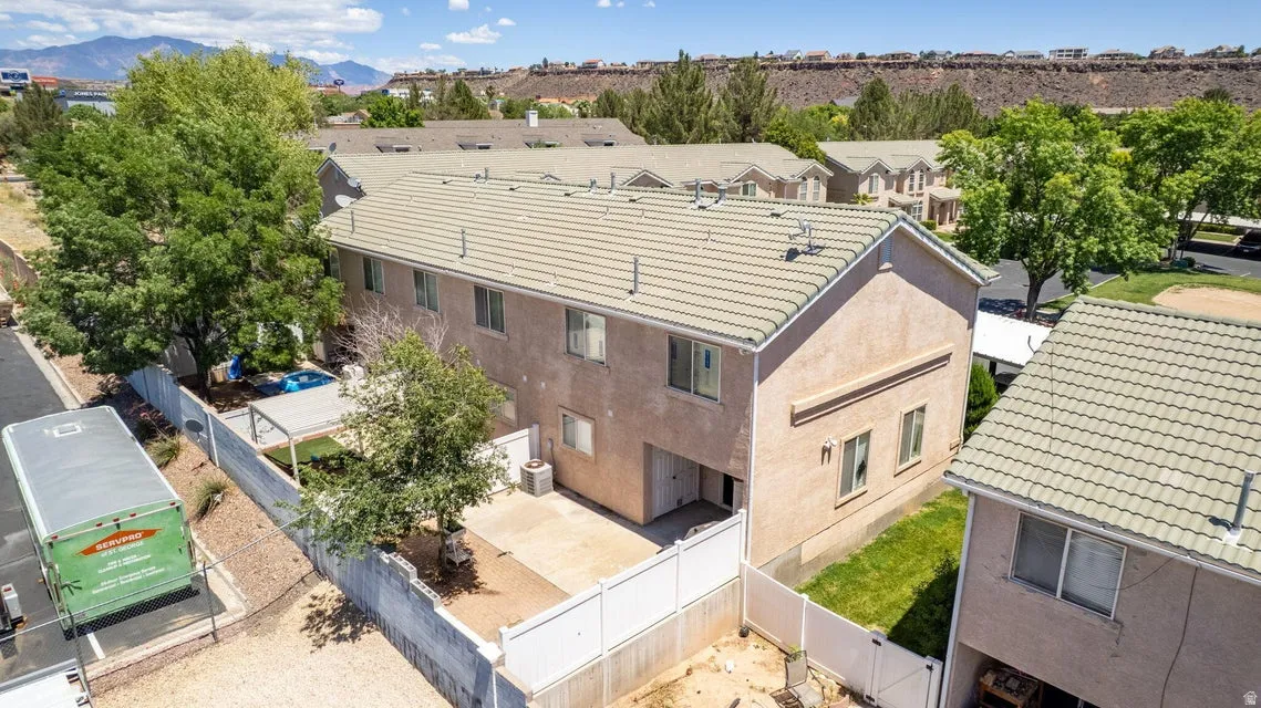 Two-story stucco townhouse with a tiled roof