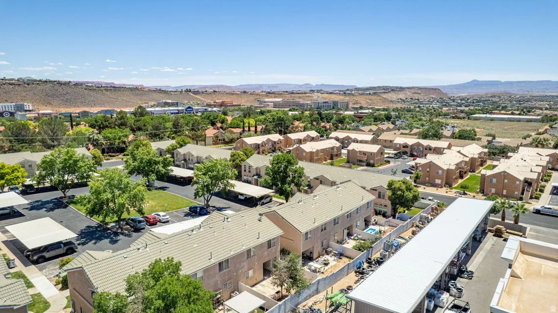 Expansive residential community featuring multiple multi-story buildings with tan stucco exteriors and light-colored roofs