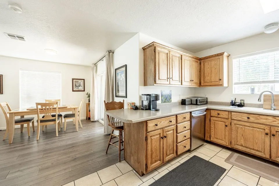 Open concept kitchen and dining area with wood-finish flooring in the dining space