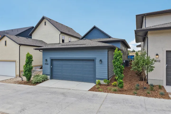 Blue siding exterior with an attached two-car garage