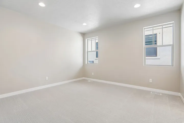 Neutral-toned walls and light carpet flooring