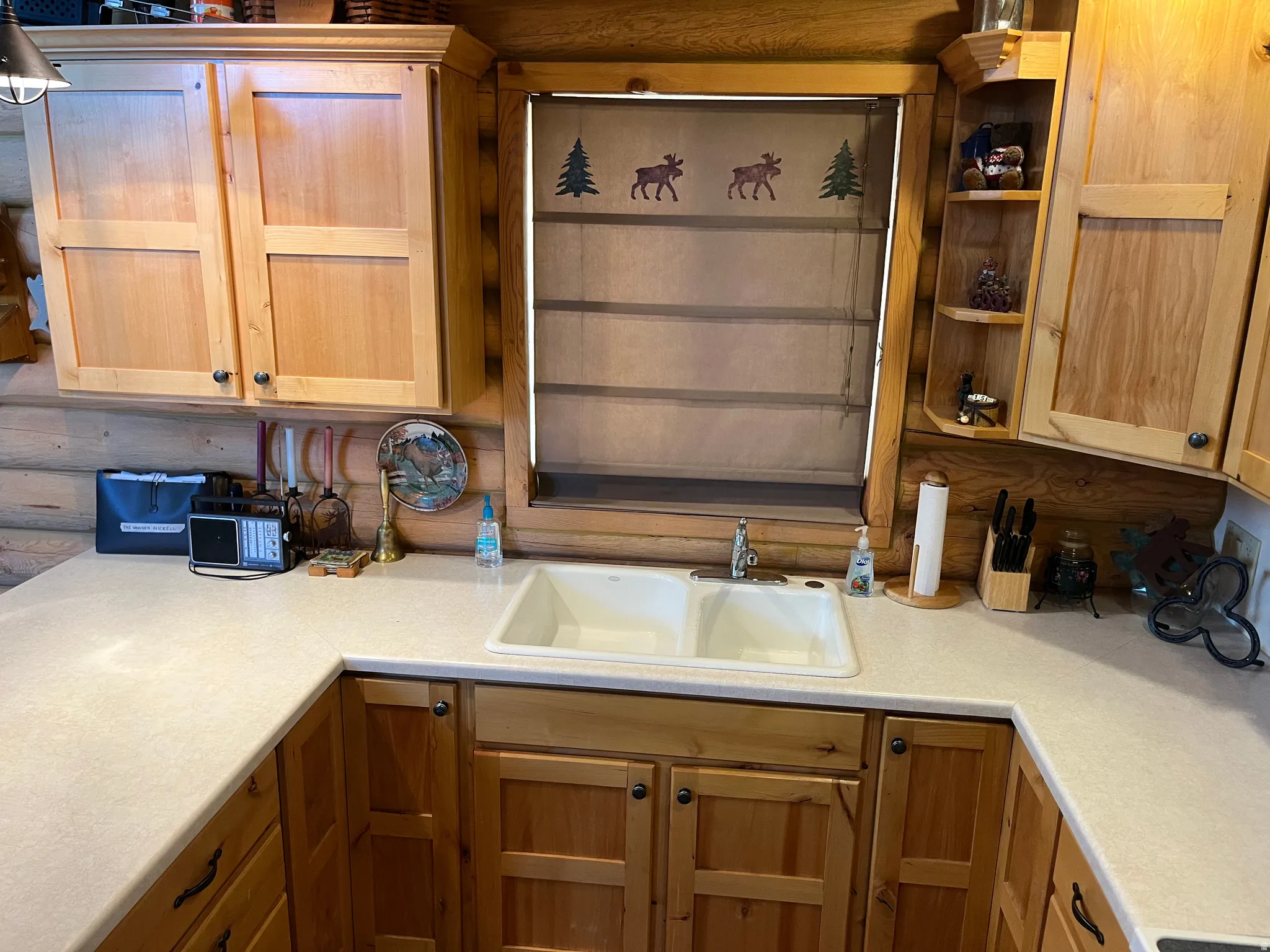 U-shaped kitchen counter with a double basin sink and light-toned countertops