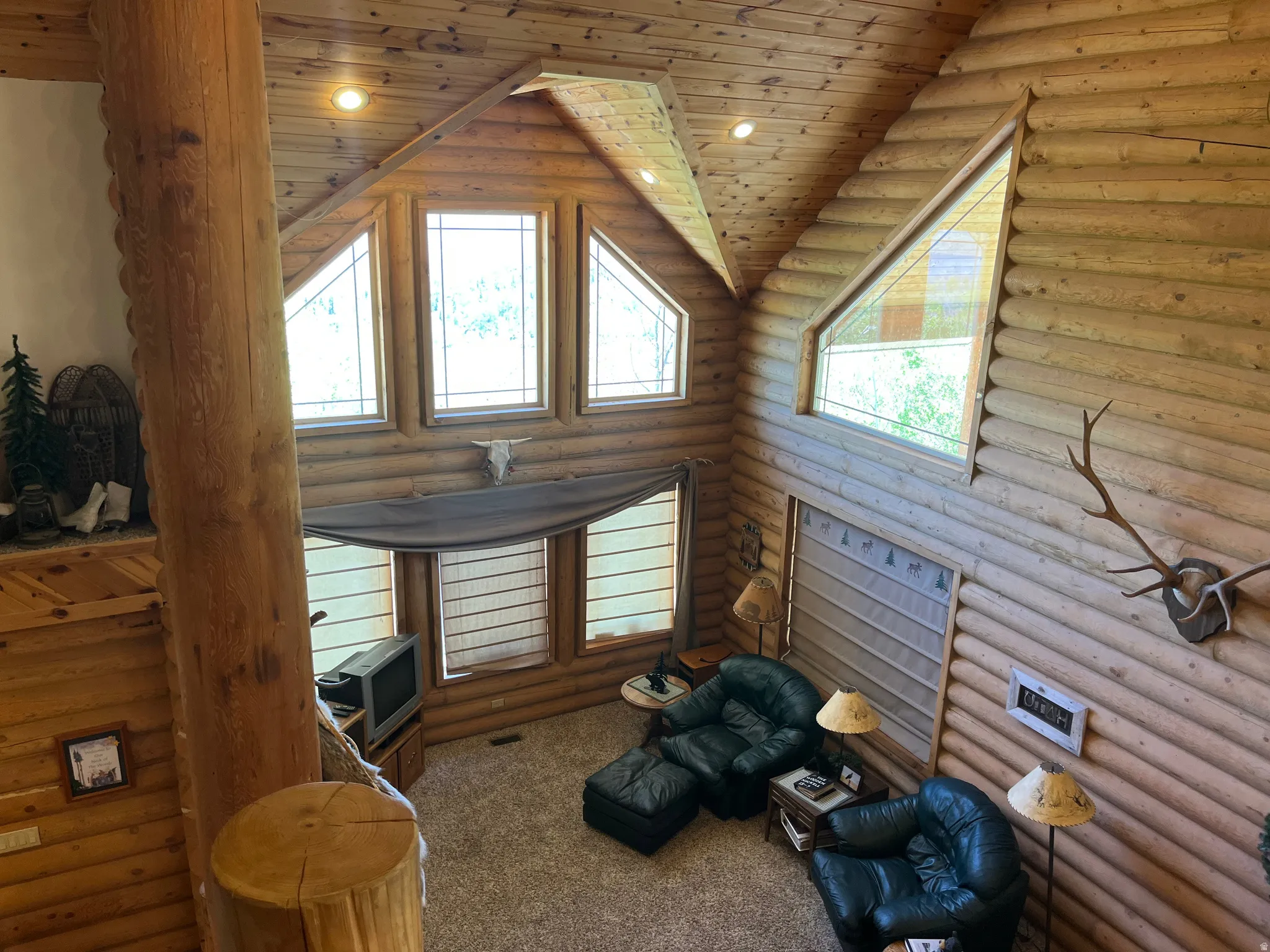 Vaulted ceiling featuring exposed wood beams and recessed lighting
