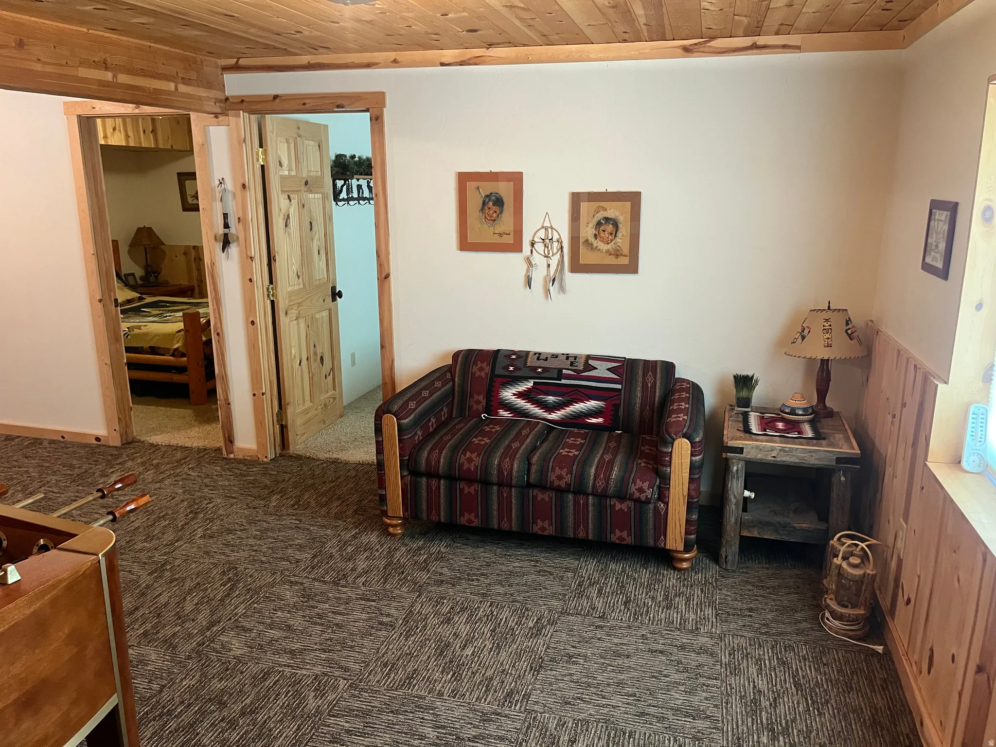Wood-paneled ceiling with recessed lighting and matching wood trim