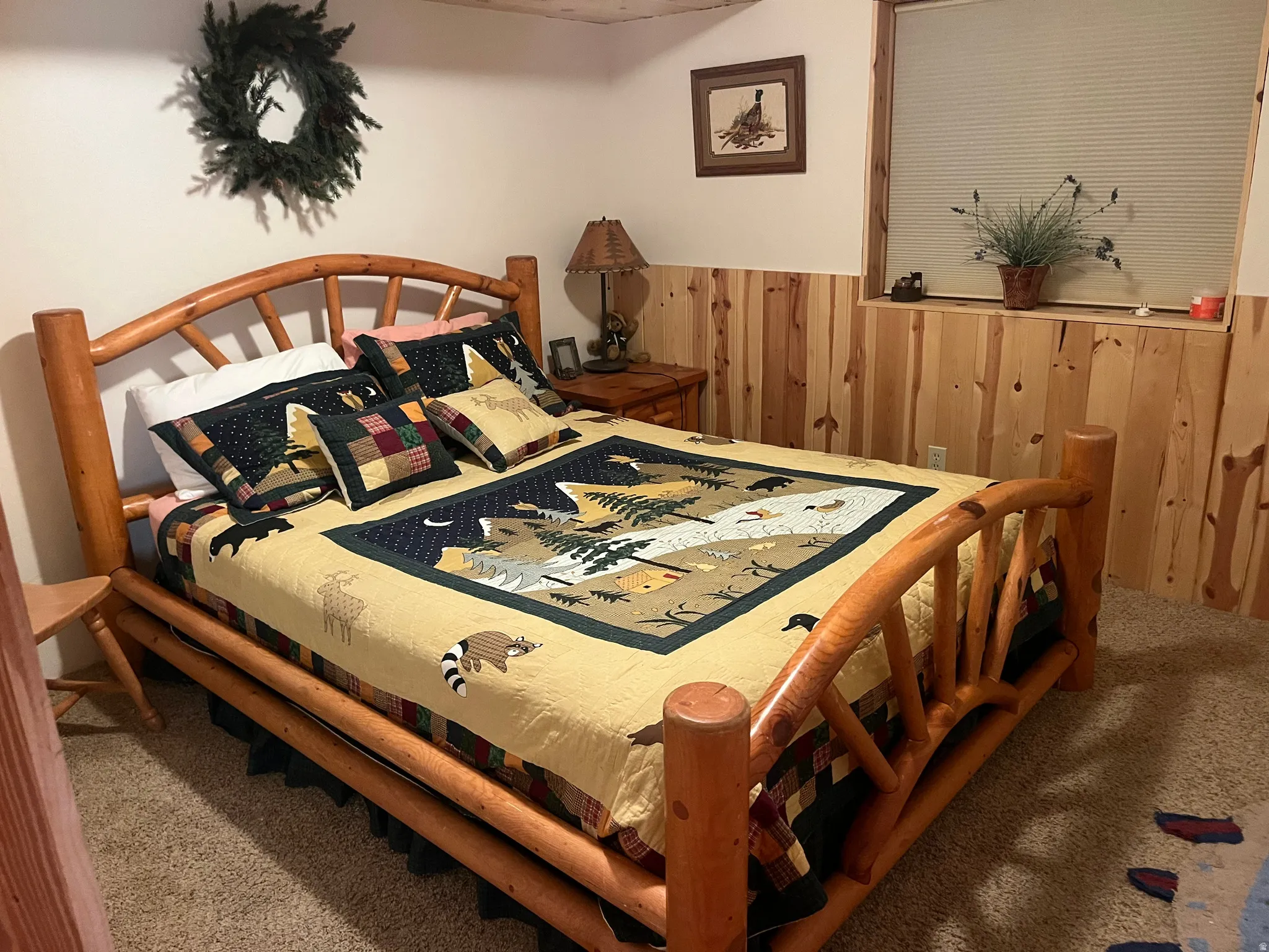 Bedroom featuring knotty pine wainscoting, a window with horizontal blinds, and carpeting