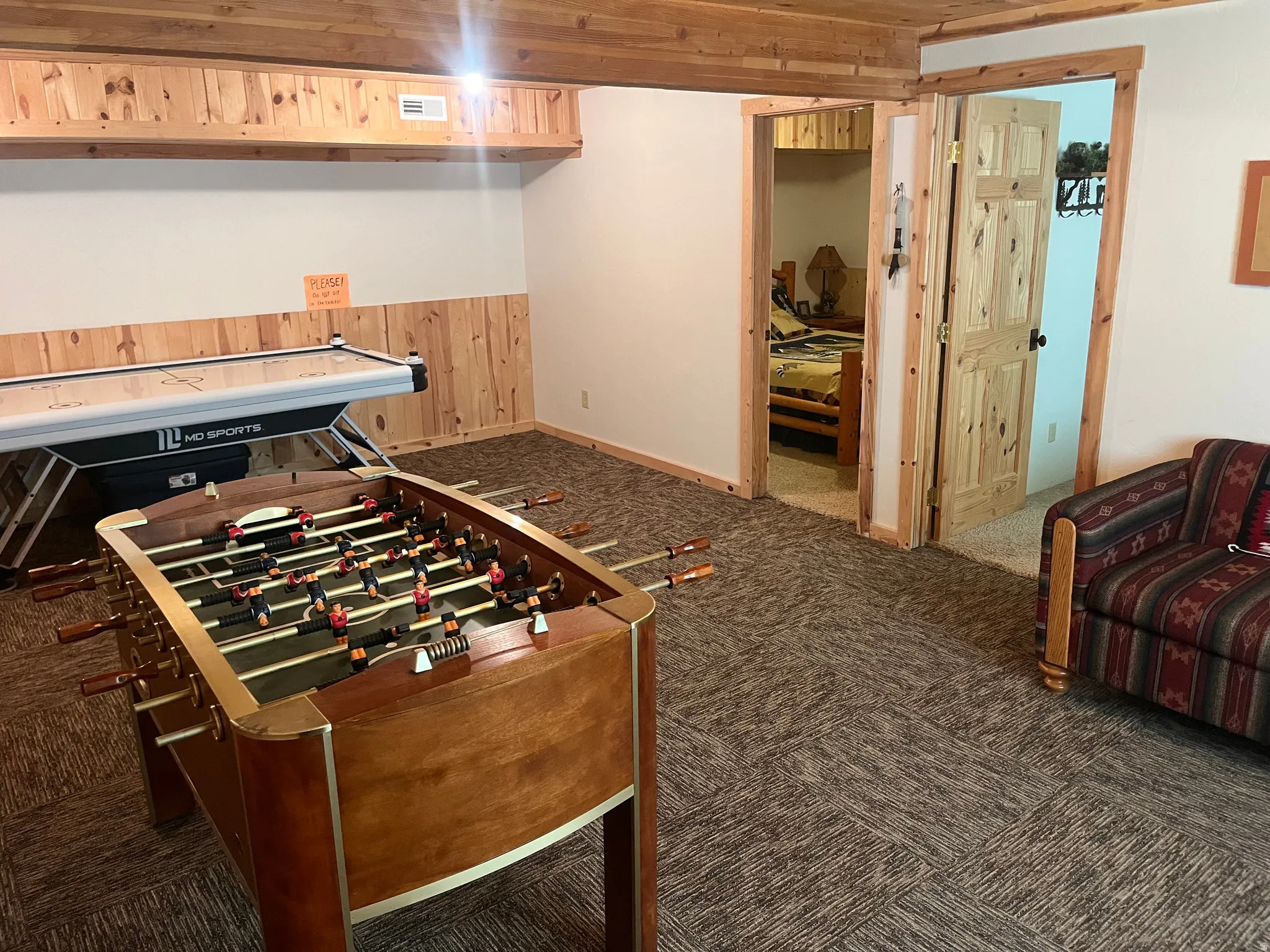 Interior space featuring wood paneling, wood-finish ceiling, and carpeted flooring