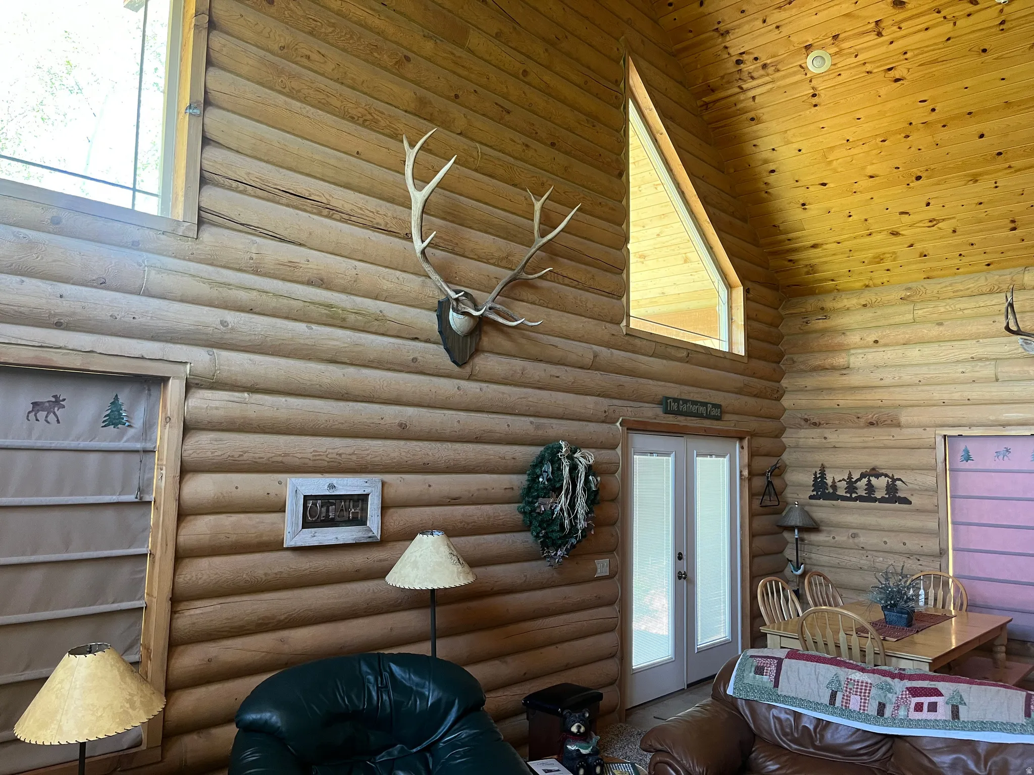 Vaulted wood-paneled ceiling with exposed log walls