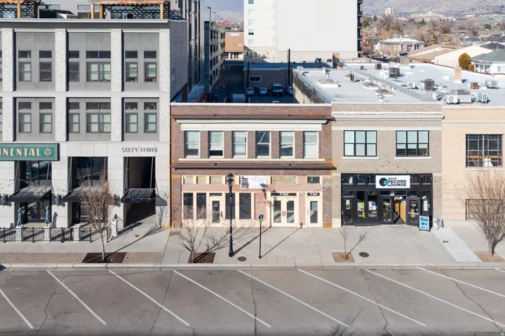 Two-story commercial building featuring a brick facade and multiple large windows