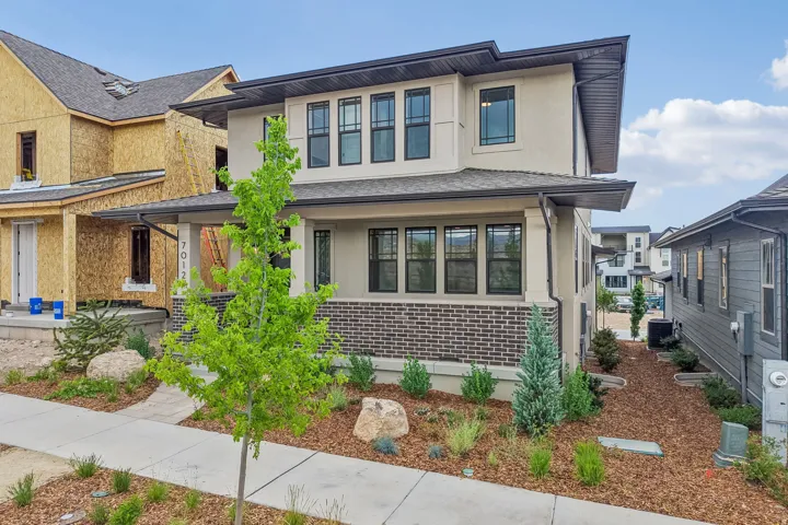 Contemporary two-story exterior with stucco and brick facade