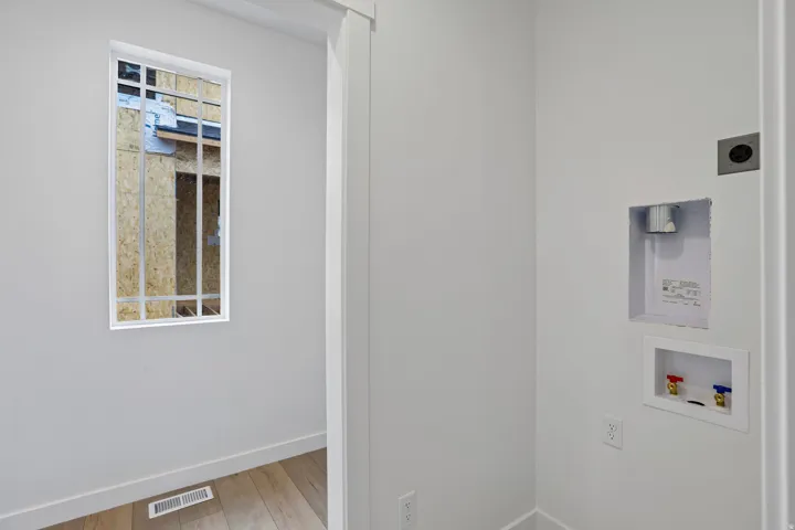 Dedicated laundry area featuring a recessed hookup box and 240V outlet