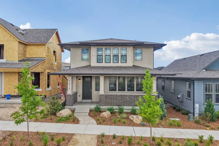 Contemporary two-story residence featuring a stucco and brick facade