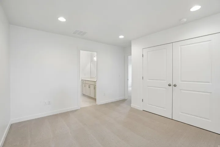 Neutral tone carpeting paired with white walls