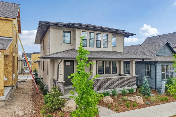 Contemporary two-story residence featuring a stucco exterior with dark trim accents