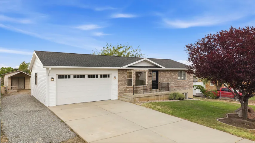 Two-story residence featuring brick and horizontal siding, a two-car garage, and a concrete driveway