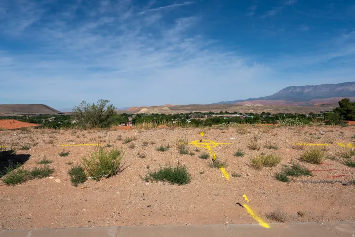 Expansive building lot featuring arid landscaping and distant mountain backdrop