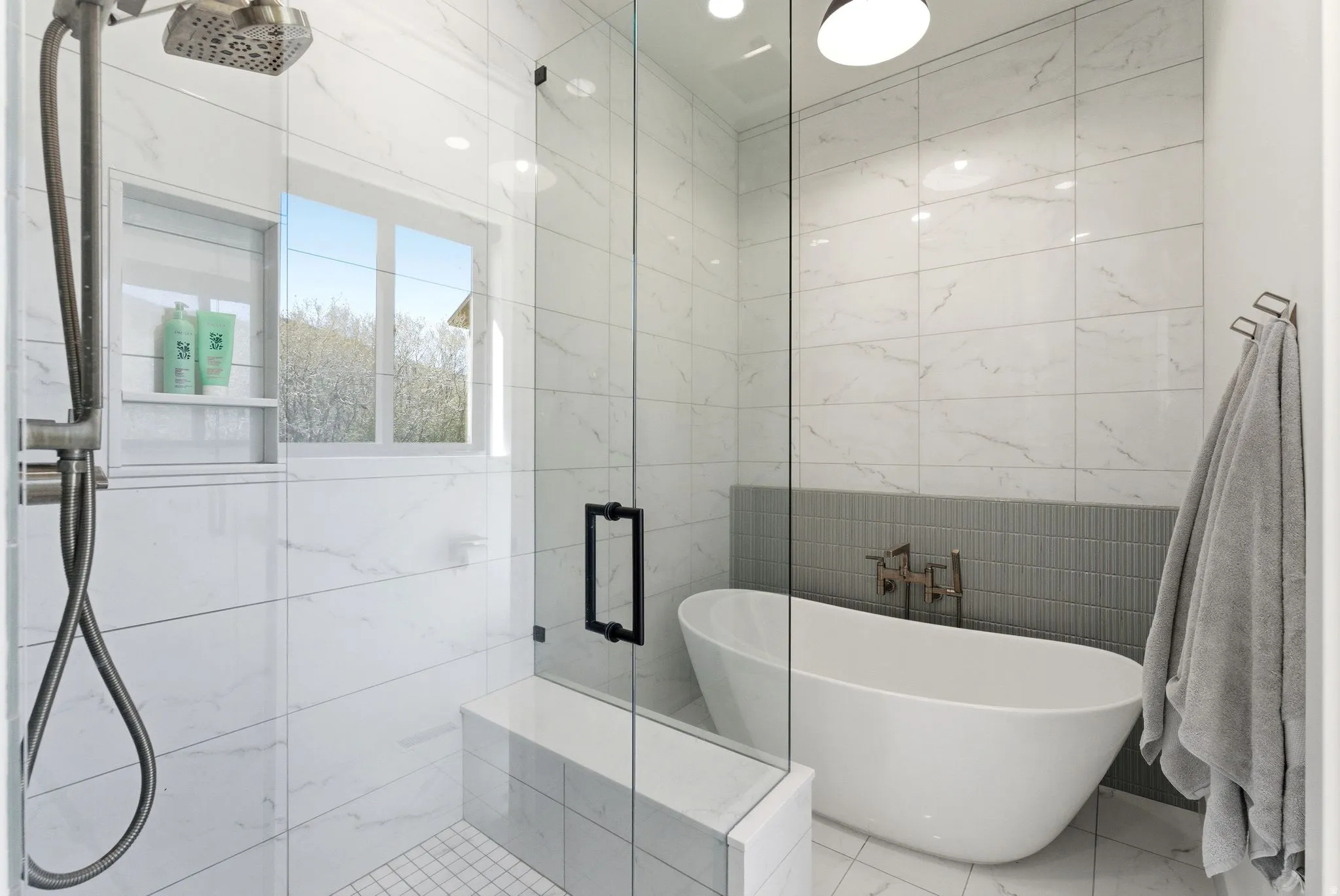 Modern bathroom featuring a freestanding tub and a glass-enclosed shower
