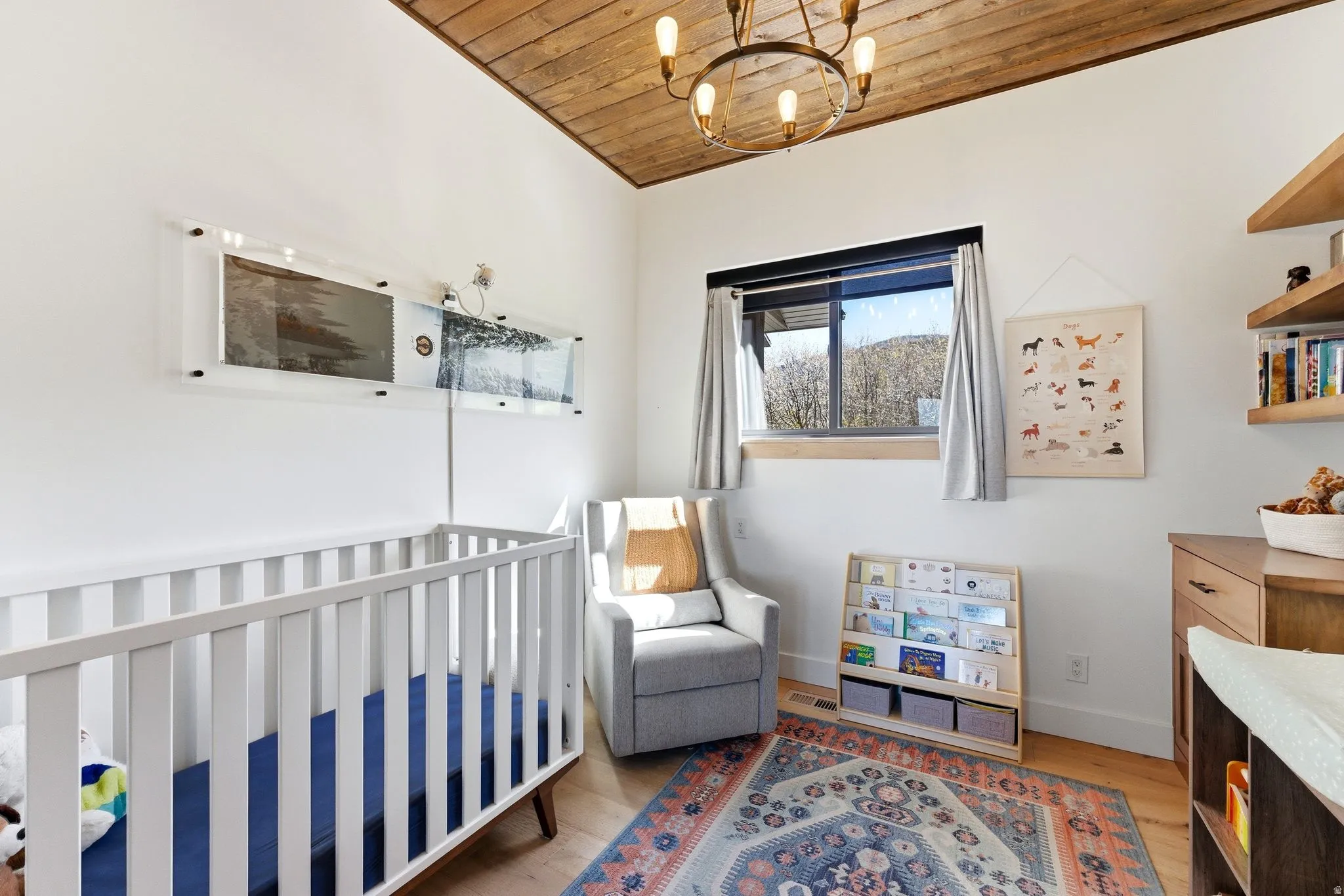 Room featuring a wood-finish ceiling, a window with a wood sill, and light wood-finish flooring