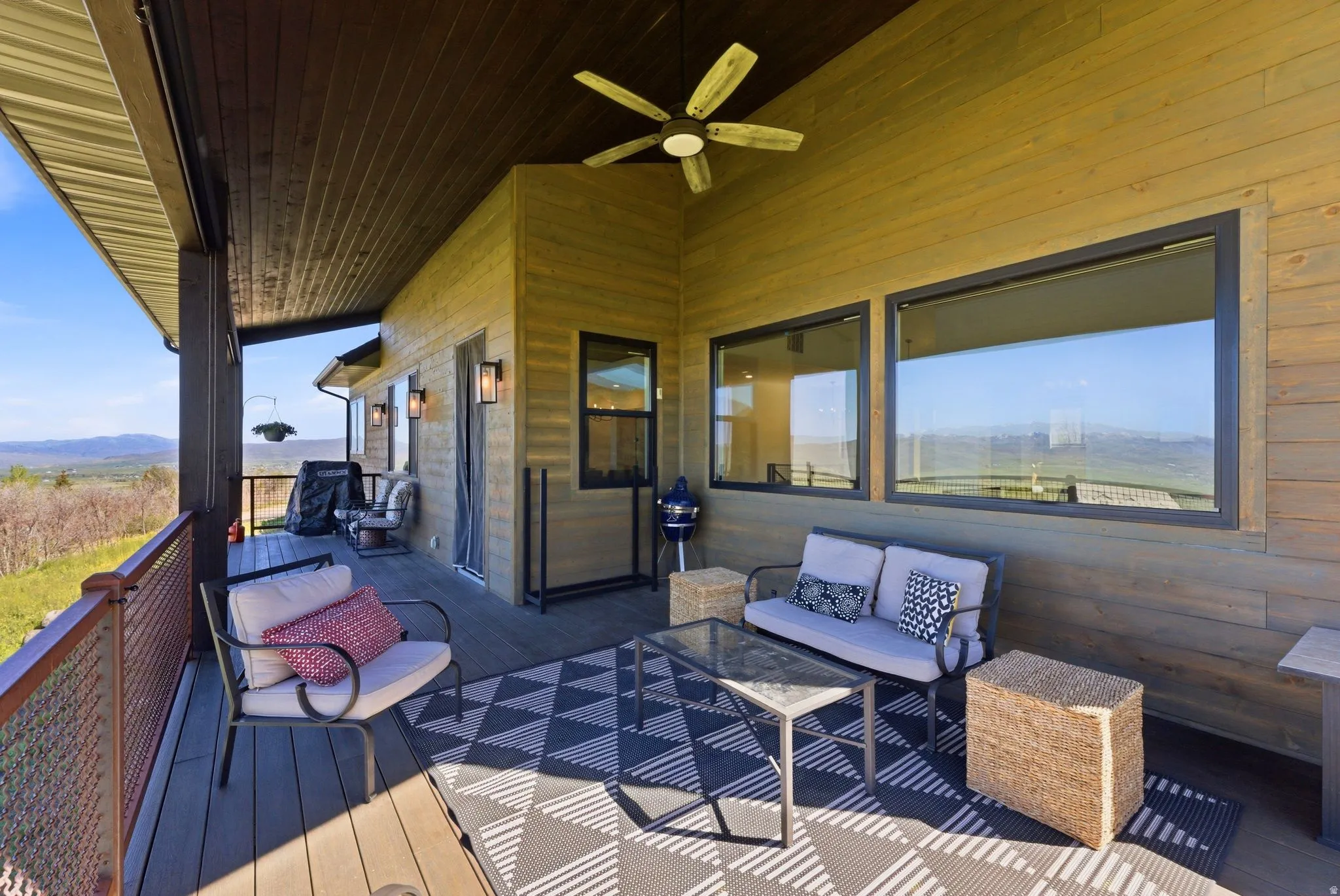 Covered outdoor living area featuring wood-finish siding and decking