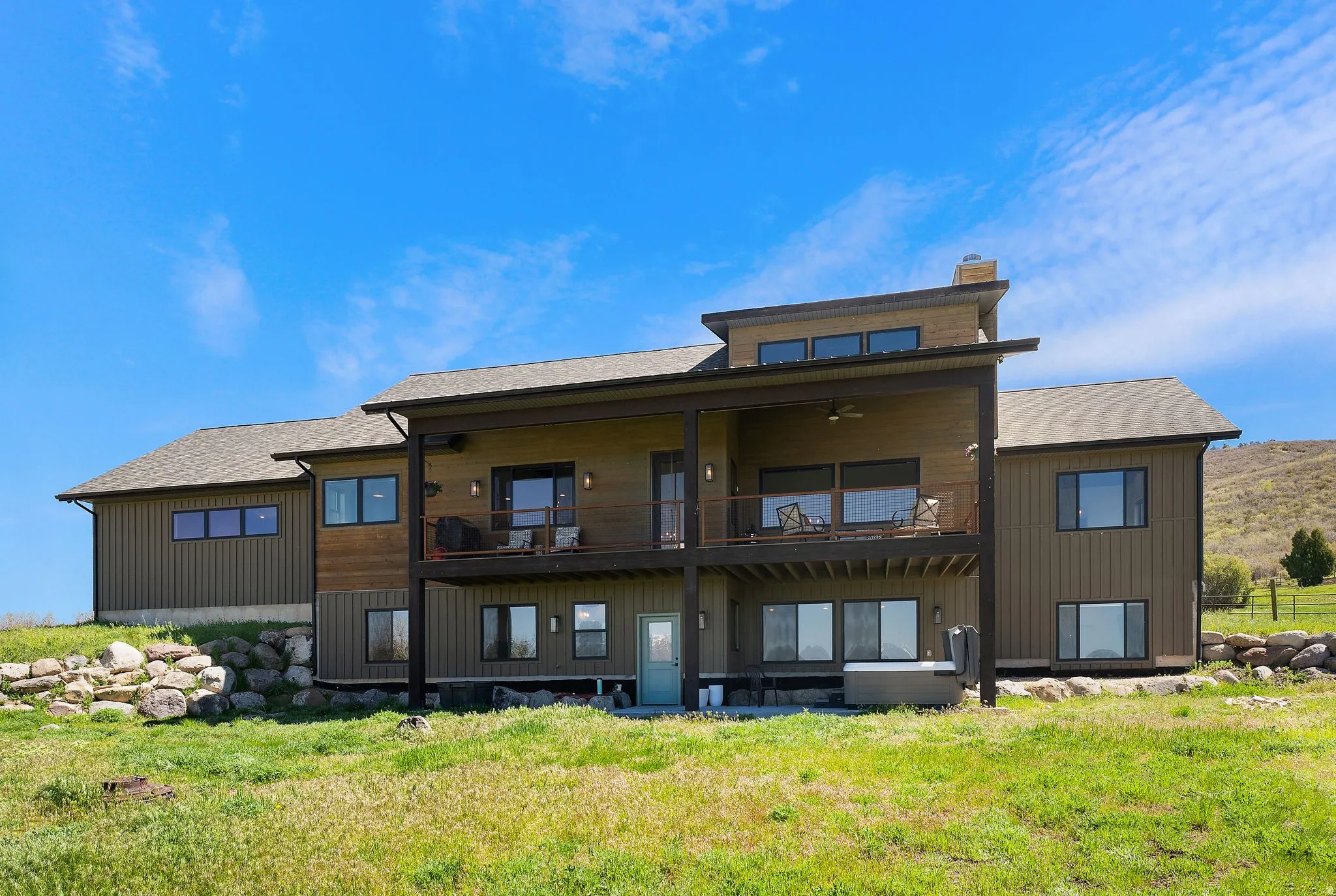 Contemporary multi-level exterior with board-and-batten siding and expansive windows