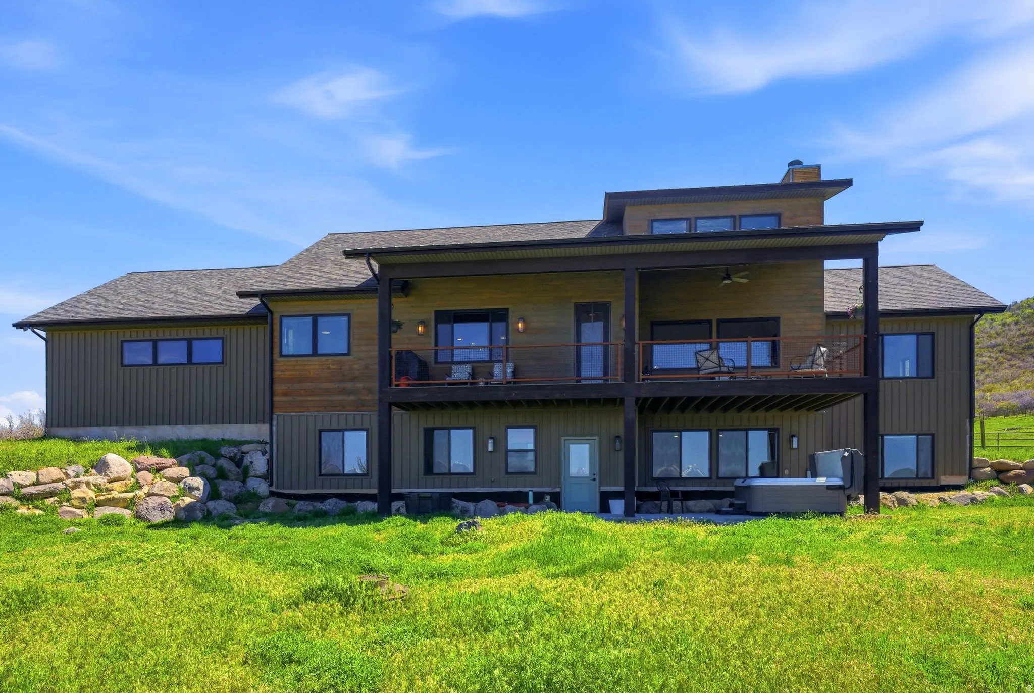 Contemporary rear facade featuring two levels of outdoor living space