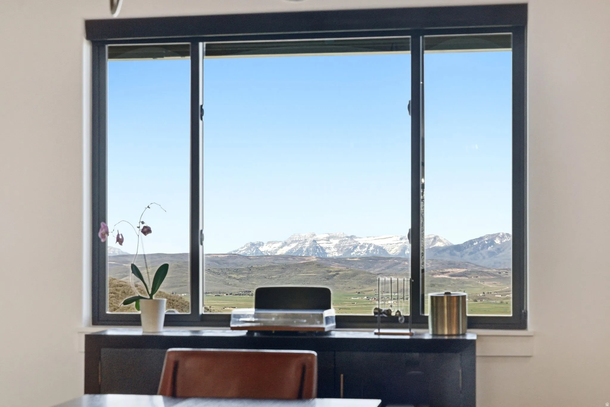 Triple-pane window with dark framing and unobstructed mountain scenery