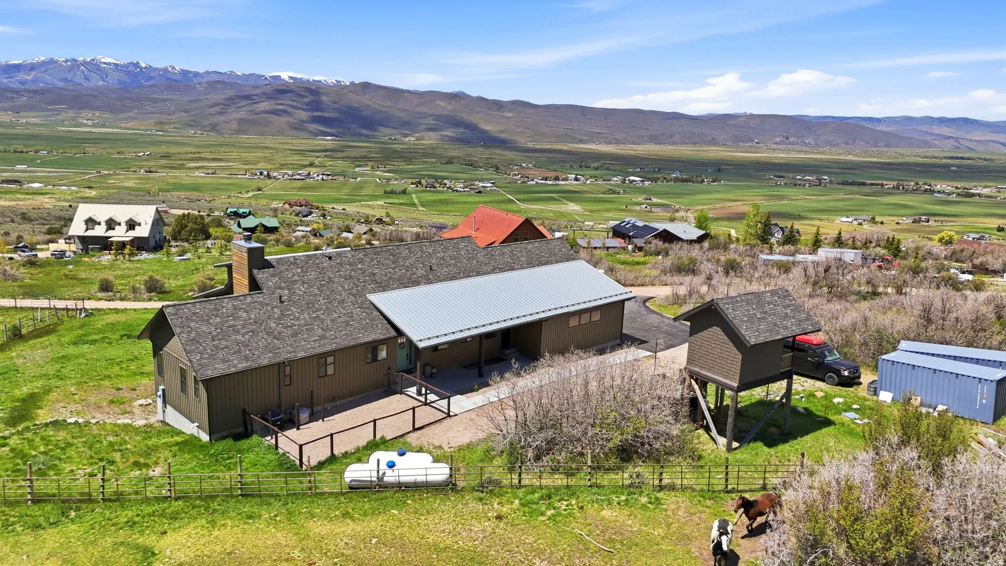 Wood-sided residence with an expansive deck and a partial metal roof