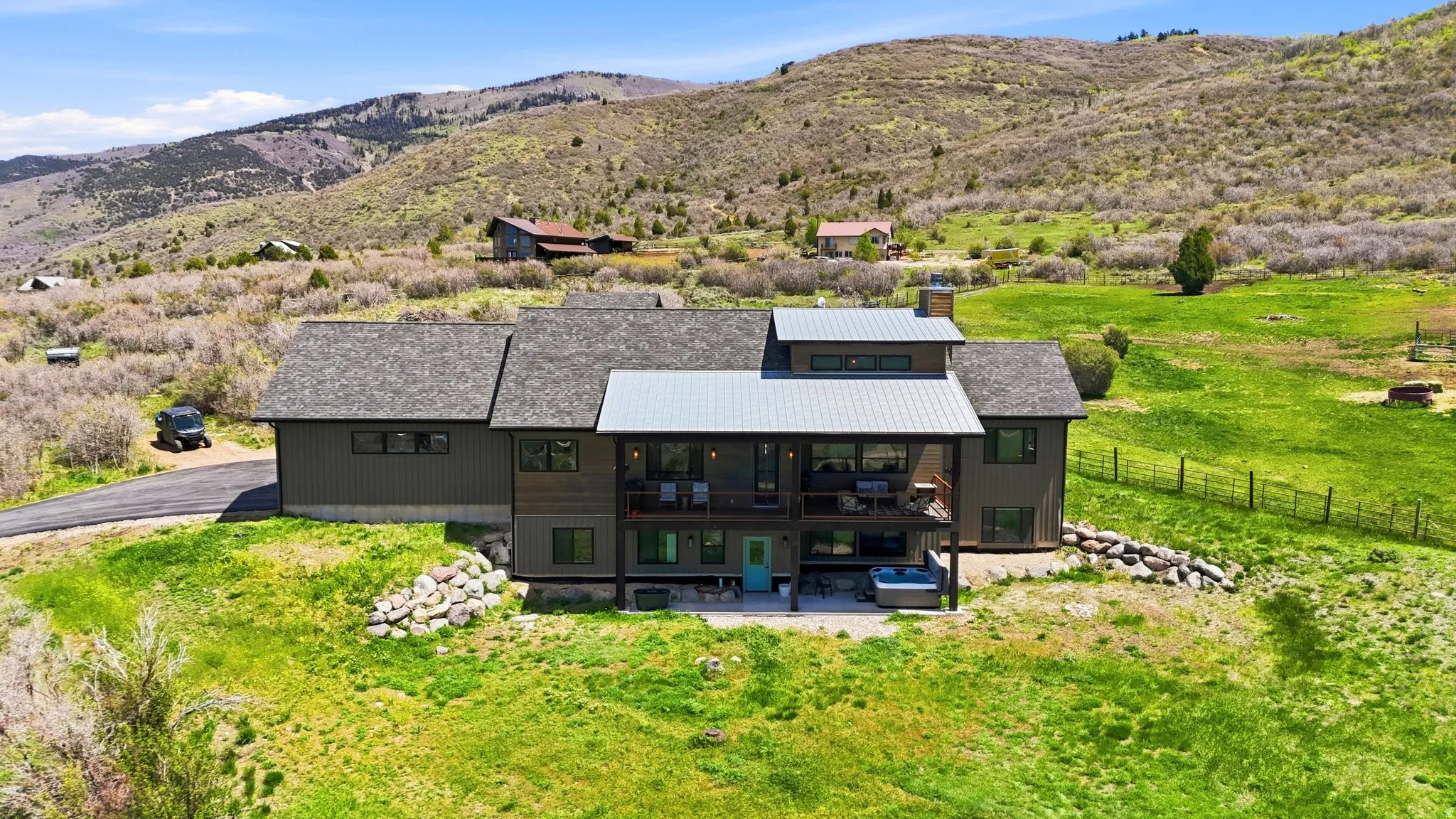 Two-story residence featuring a dark-toned exterior, multiple gabled roofs, and a metal roof accent