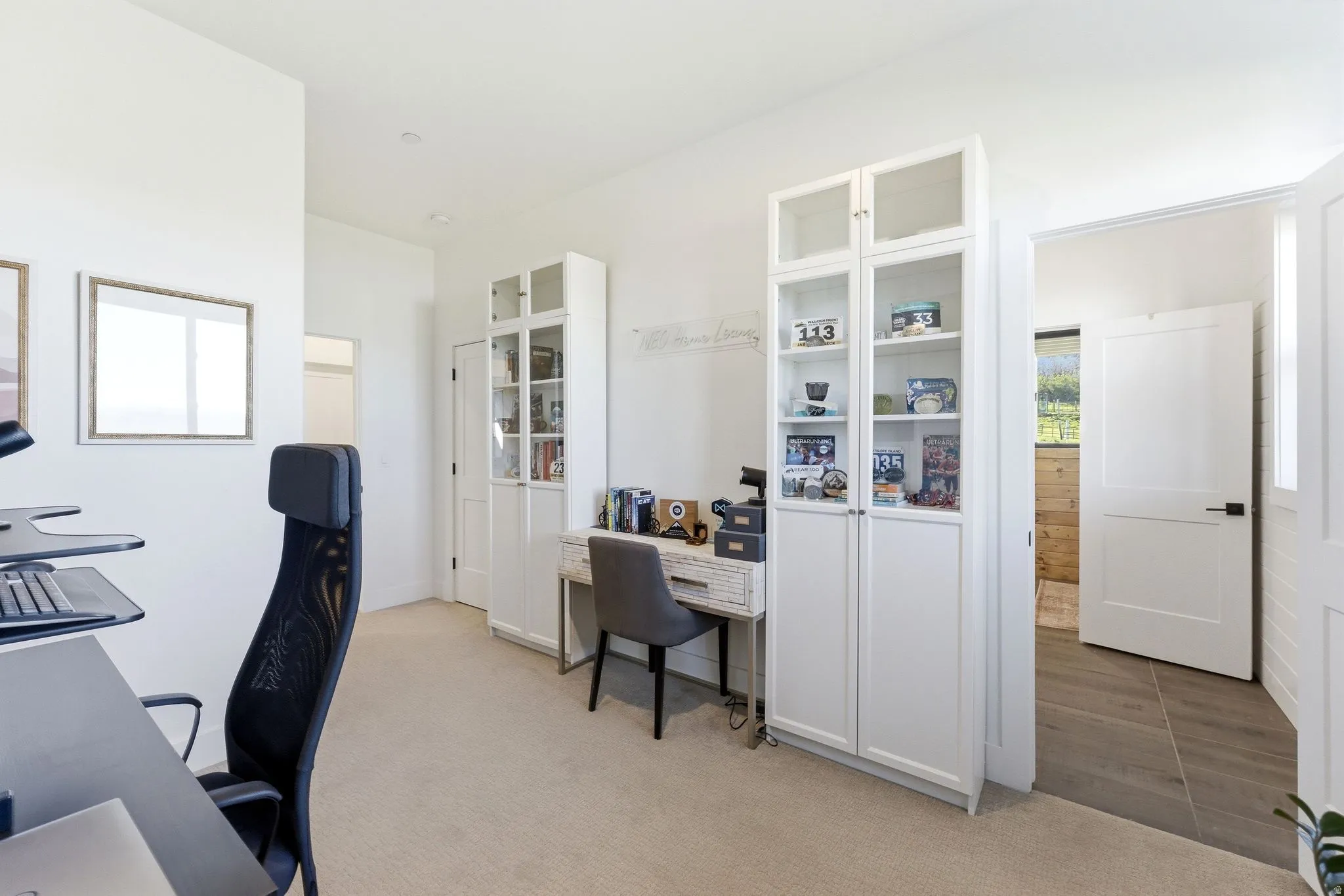 White interior walls with recessed lighting and neutral carpet flooring