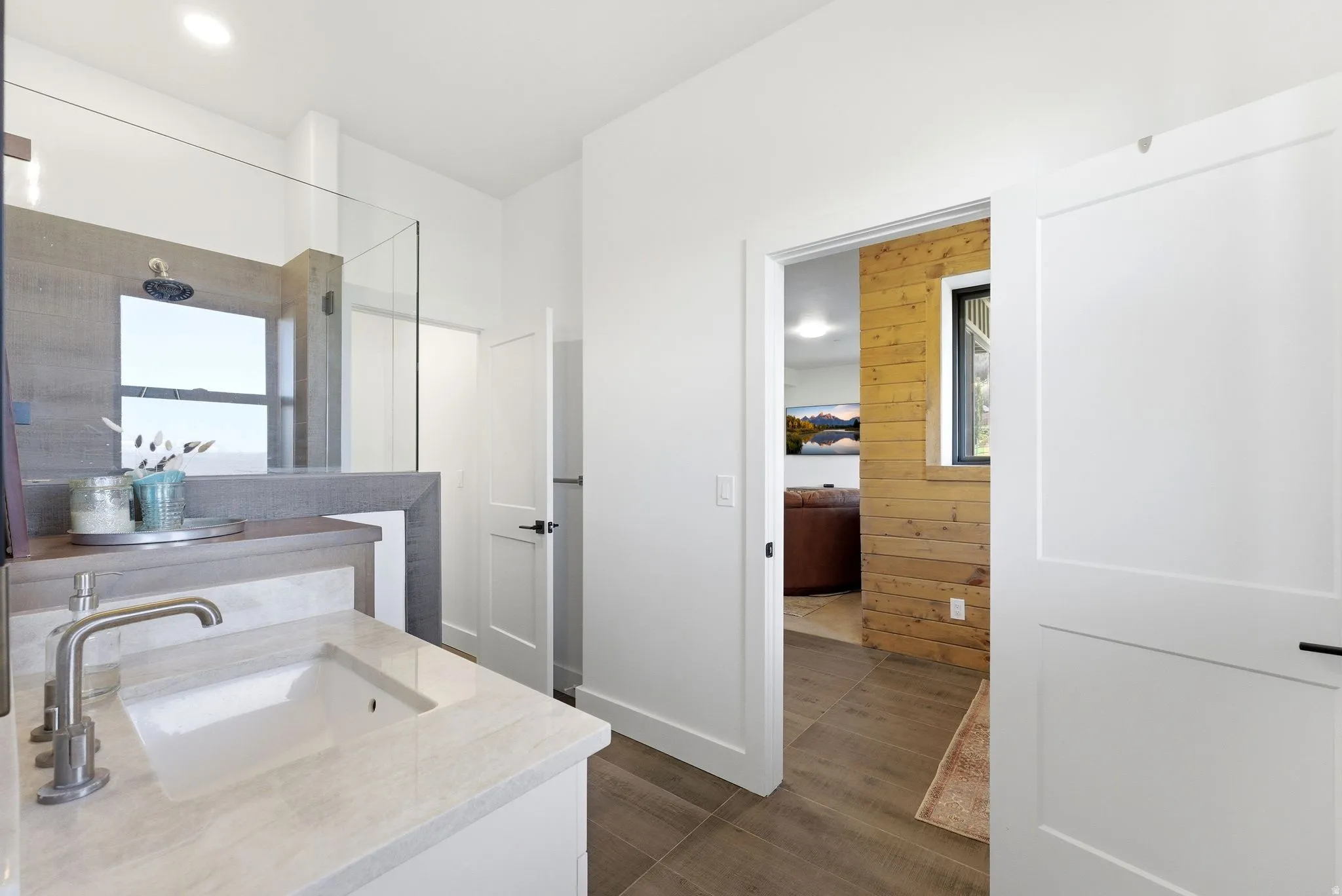 Modern bathroom featuring a single vanity with an undermount sink and a light-toned countertop