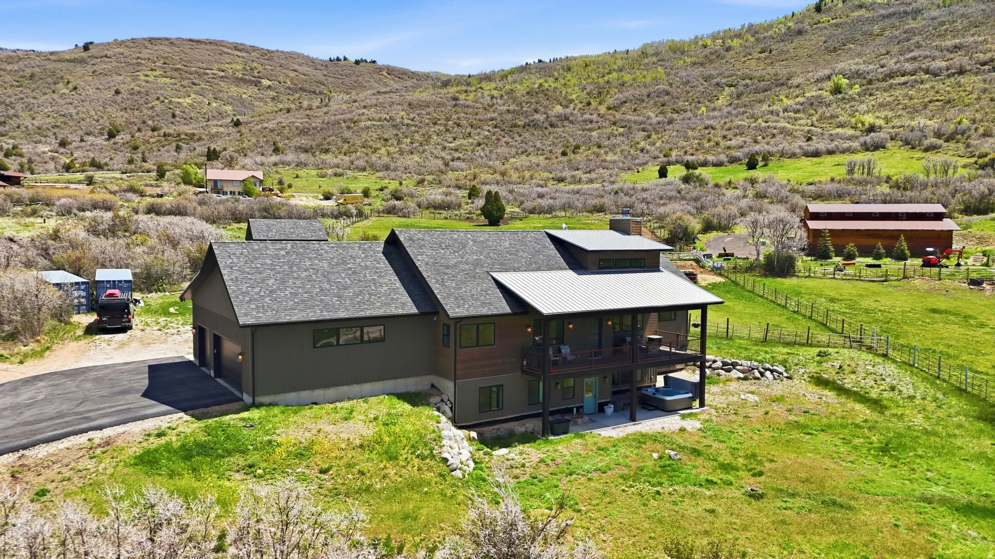 Contemporary home featuring a dual-tone exterior, attached two-car garage, and a covered balcony