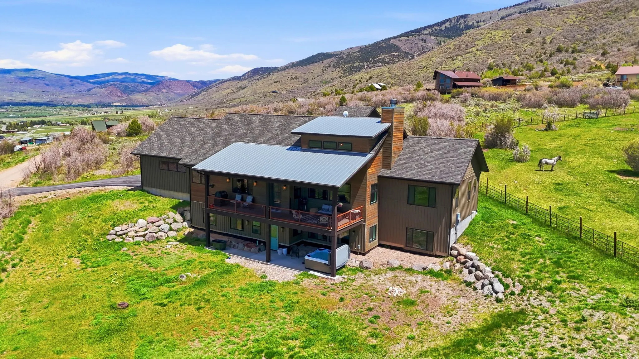 Contemporary-style residence with multi-level decks and a metal roof
