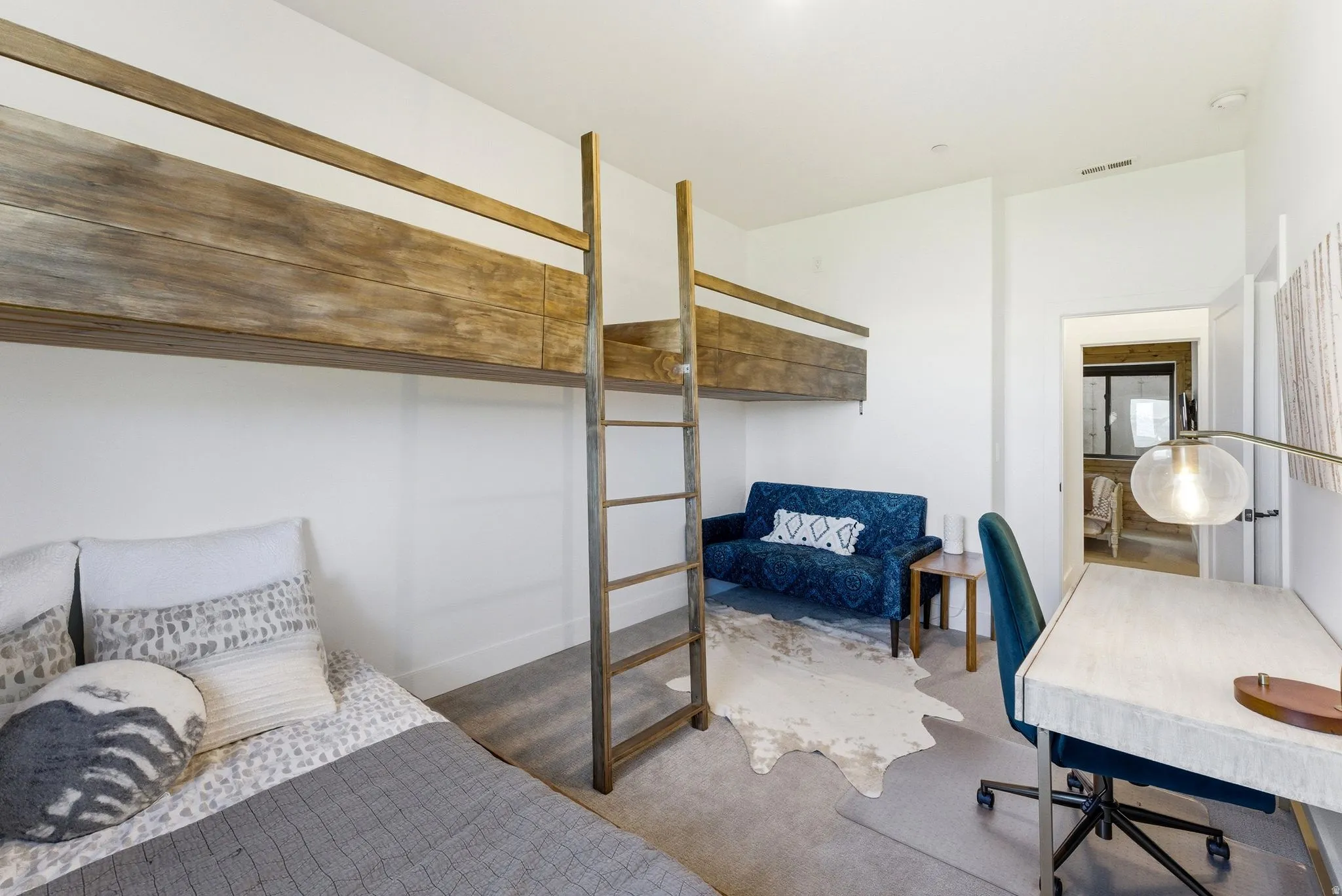 Bedroom featuring a built-in bunk bed system with wood-finish frames and ladders, neutral wall paint, and gray carpeting