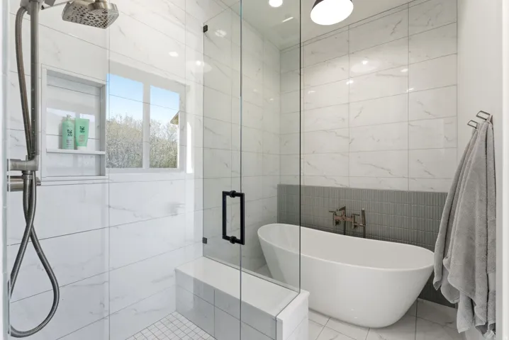 Modern bathroom featuring a freestanding tub and a glass-enclosed shower