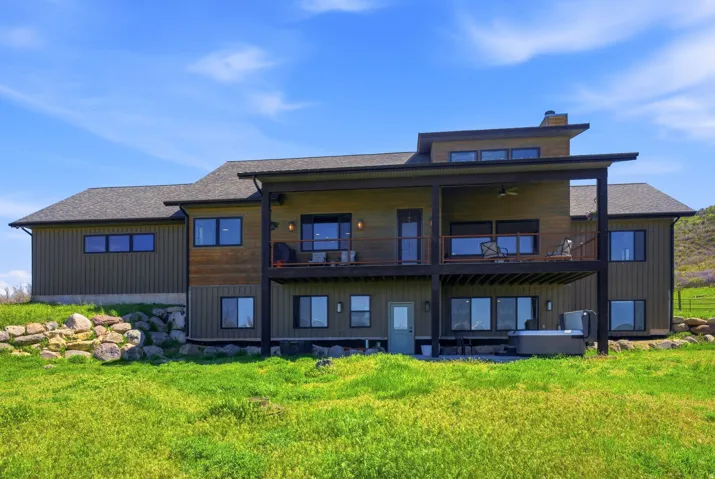 Contemporary rear facade featuring two levels of outdoor living space
