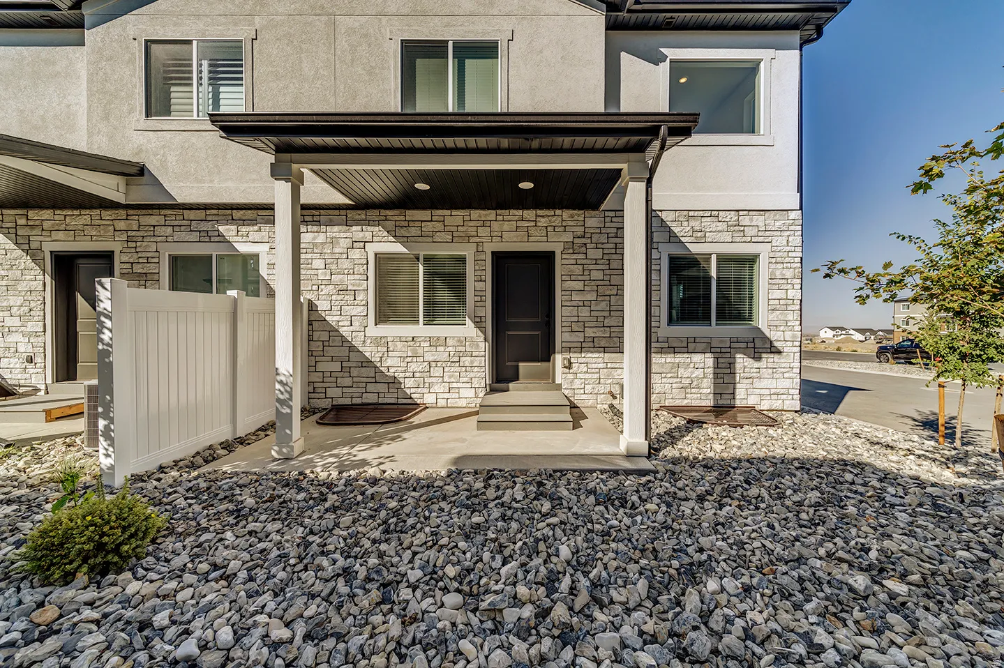 Stone veneer and stucco exterior with a covered porch entry