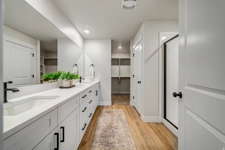 Dual vanity with integrated sinks and black matte fixtures, set against a full-width mirror