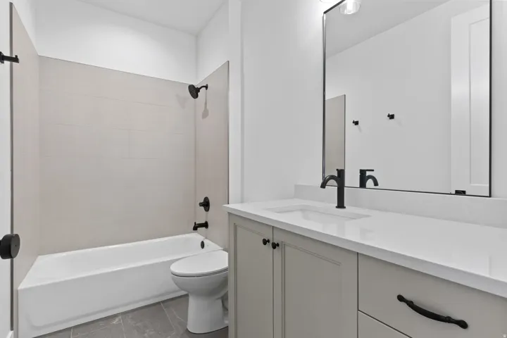 Bathroom featuring a light-toned vanity with a white countertop and rectangular undermount sink