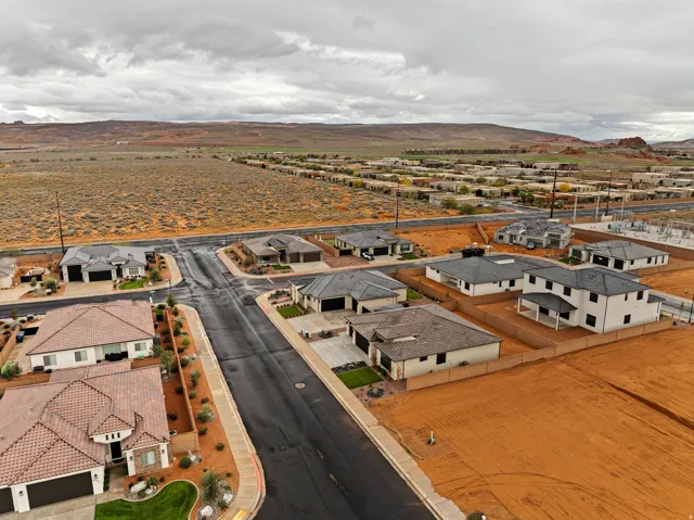 Residential neighborhood featuring diverse architectural styles and red rock landscaping